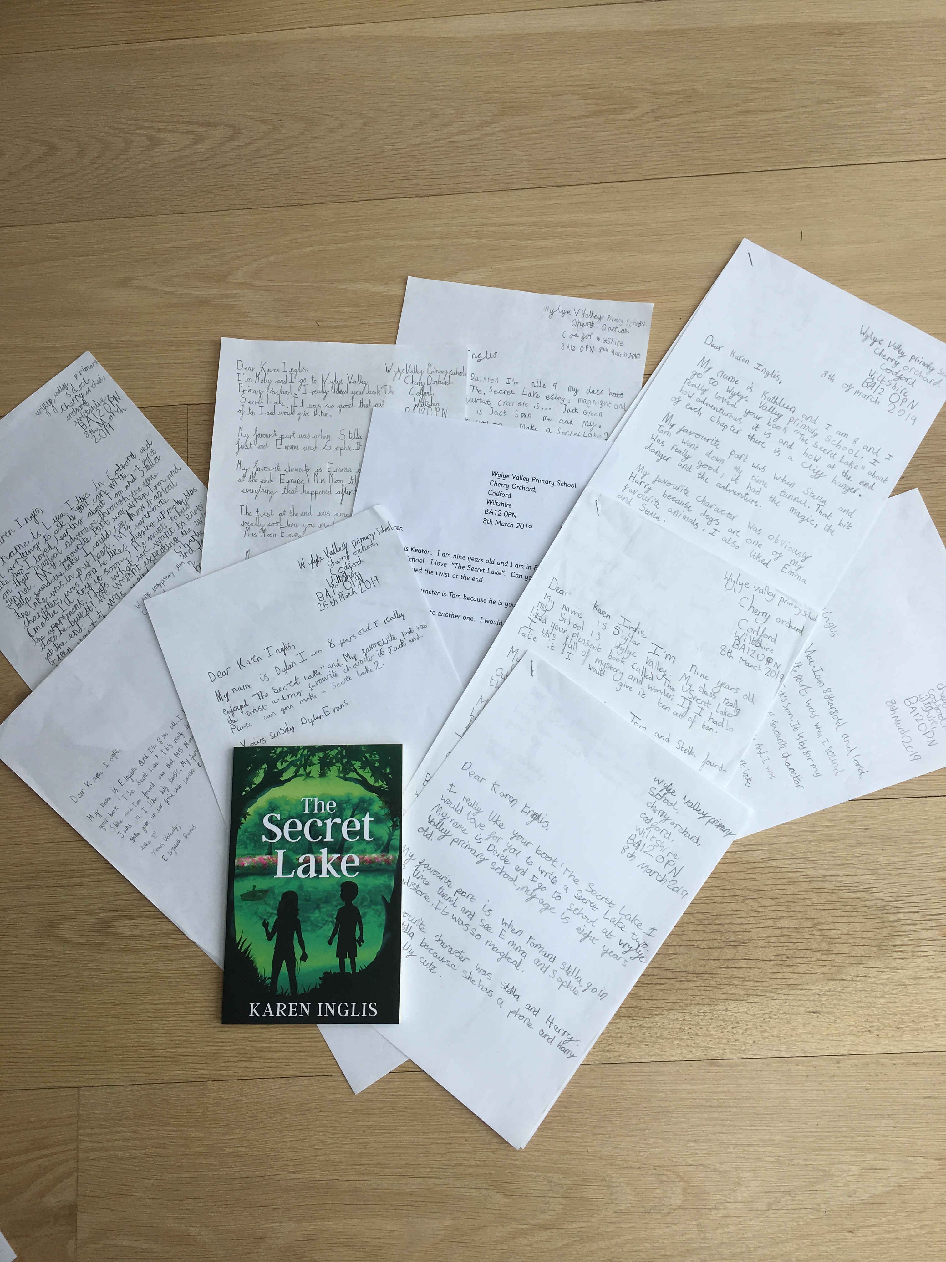 hand written letters arranged with a copy of The Secret Lake children's book